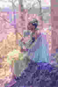 spring fairy sitting atop a boulder