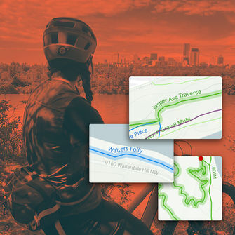 A mountain biker at a trailhead in Edmonton, looking at the river