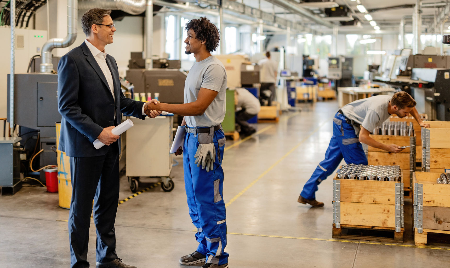 happy-black-manual-worker-engineer-handshaking-while-greeting-industrial-building(1)_edite