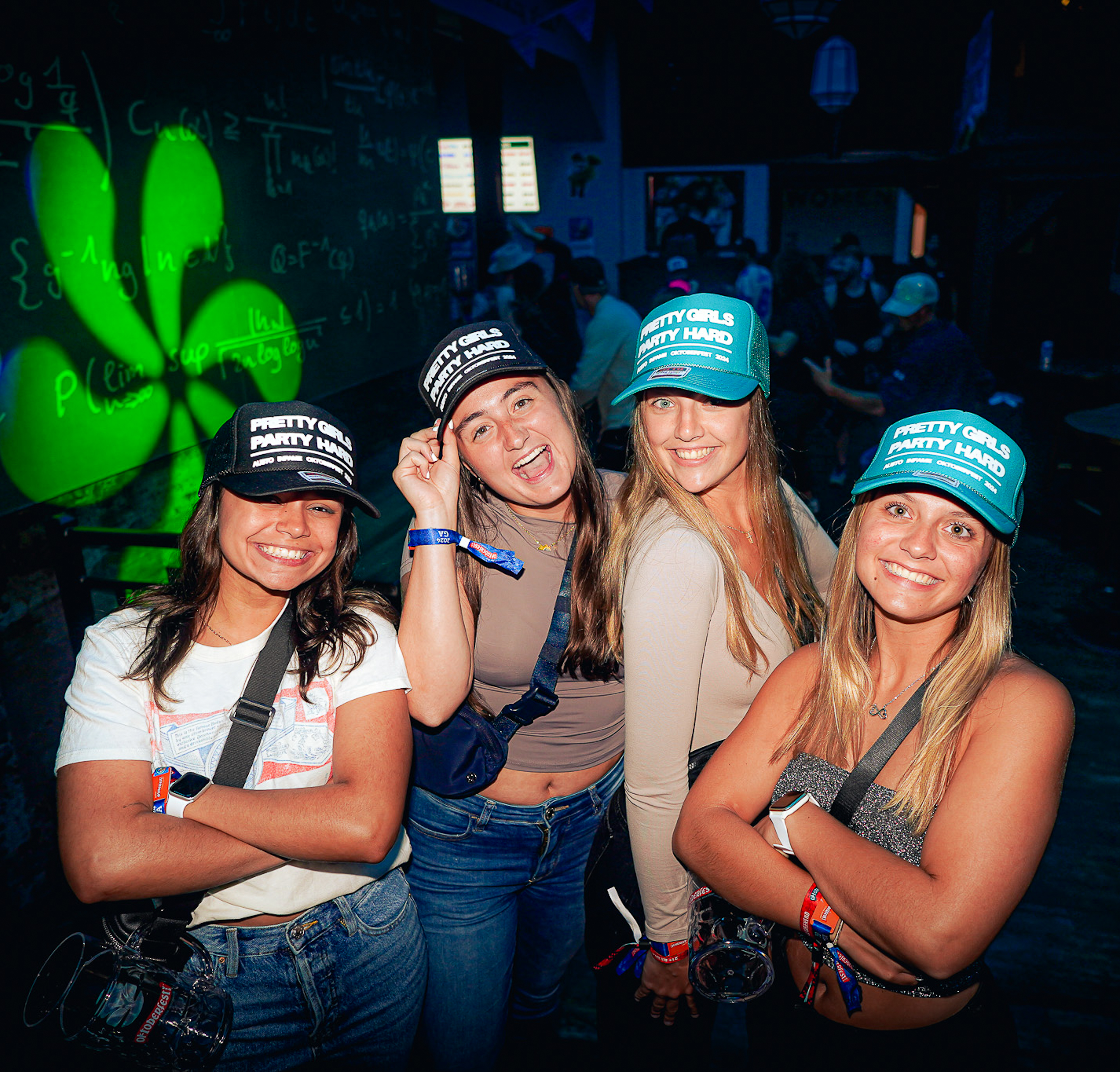 College nightlife attendees wearing branded hats