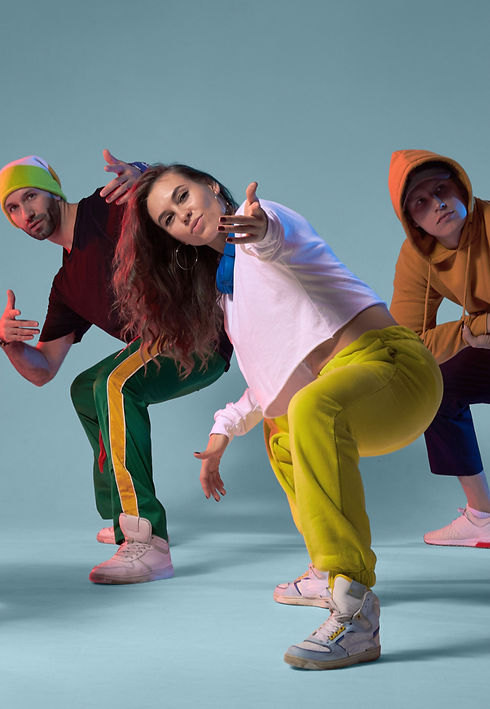 Let’s Build Your Event Experience - High-energy hip-hop dancers in a welcoming stance, extending an open hand to invite clients to submit details for a corporate wellness or festival entertainment quote.