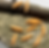 Thumbnail: Peachy salmon colored artificial wax worm sitting on a rock
