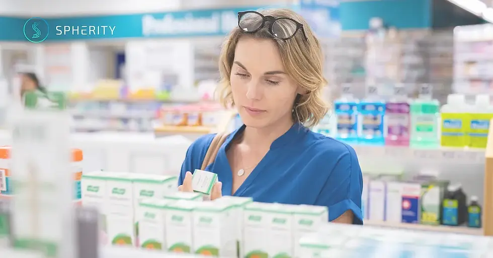 Woman in a pharmacy aisle holding a medication box, with blurred shelves of products in the background and the Spherity logo in the top-left corner.