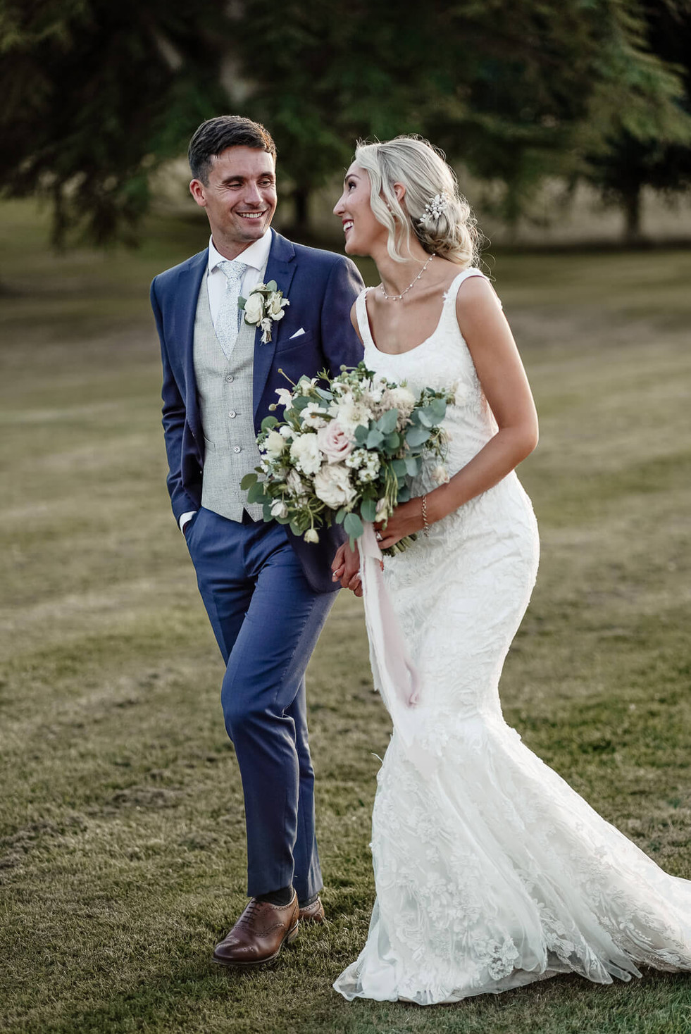 Relaxed and natural wedding portrait of bride and groom at Hawkstone Hall & Gardens, captured by WedVibes.