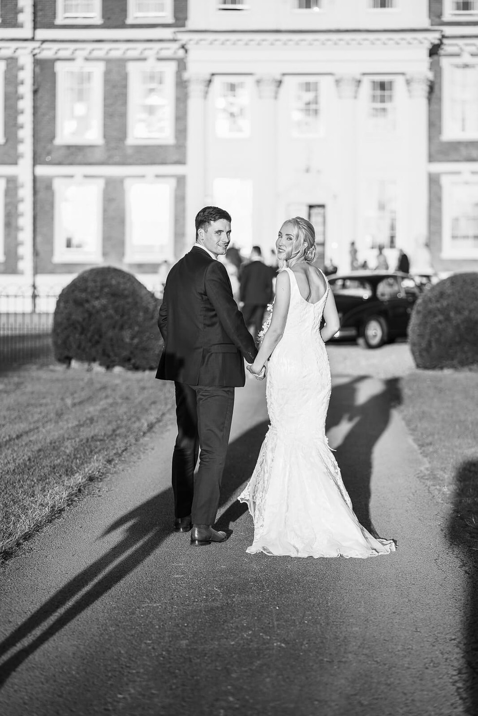Elegant bridal portrait indoors at Hawkstone Hall & Gardens, featuring the bride holding her bouquet, photographed by WedVibes.
