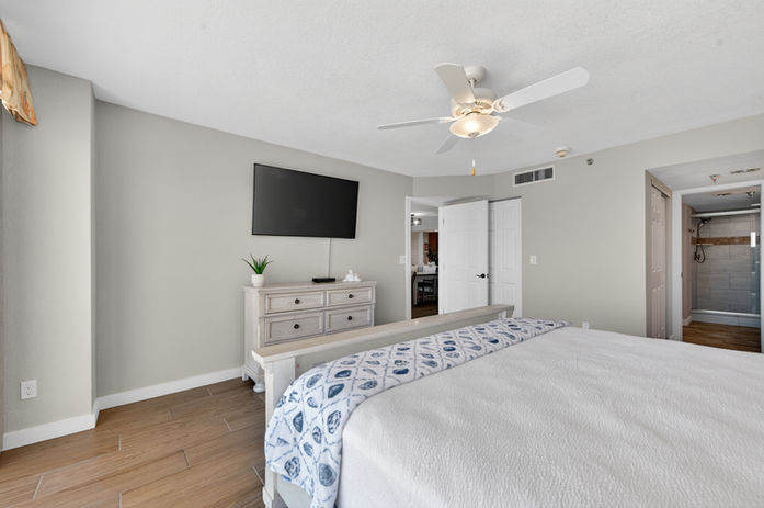 Primary bedroom with king bed and walk-in closet