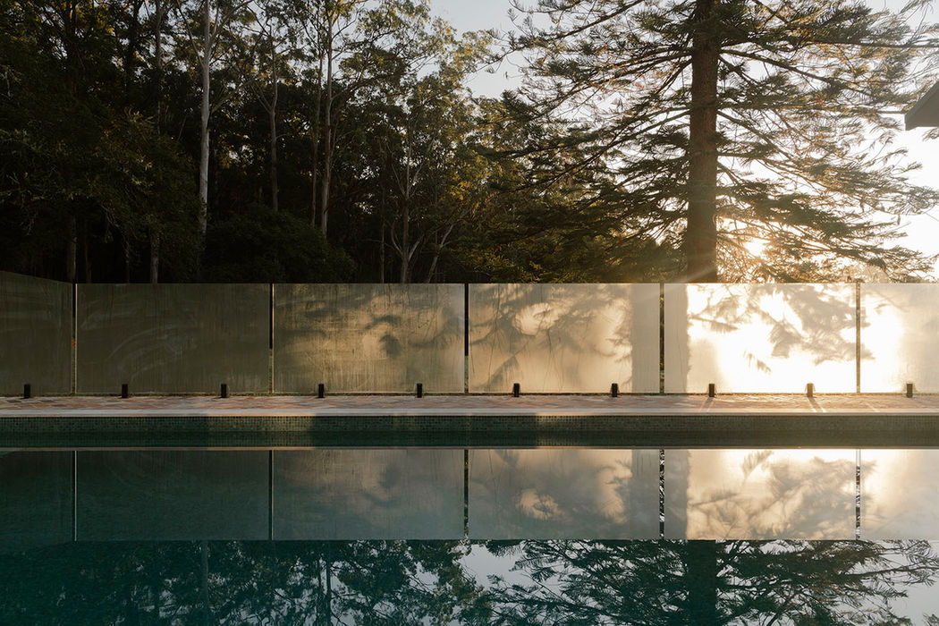 Professional pool fencing reflects the surrounding landscaping for this luxury pool.
