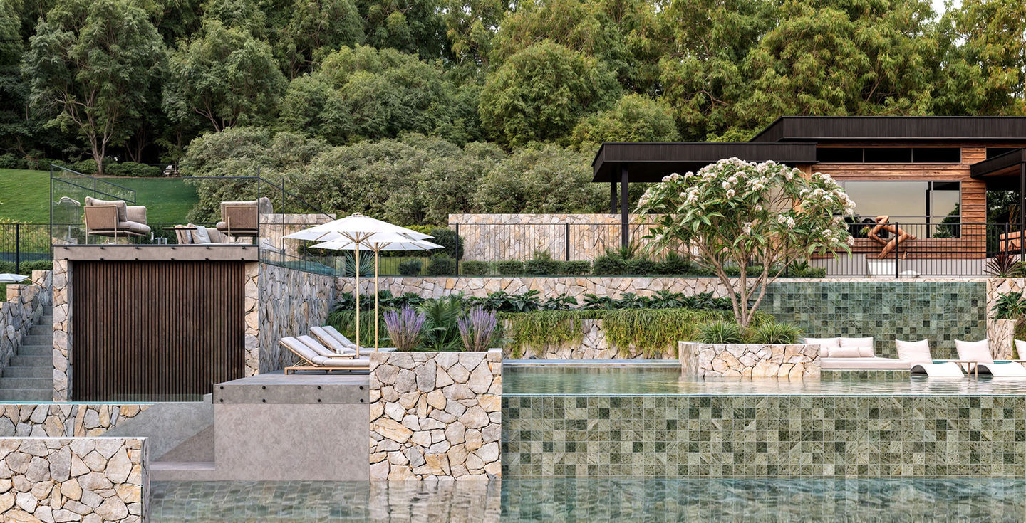 A luxury sprawling outdoor entertainment area and pool. Multi tiered on the hillside surrounded by lush landscaping throughout stone, tile, timber and concrete.