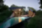 Stunning luxury pool with turf roof and floor to roof glass windows and indulgent lounge chairs