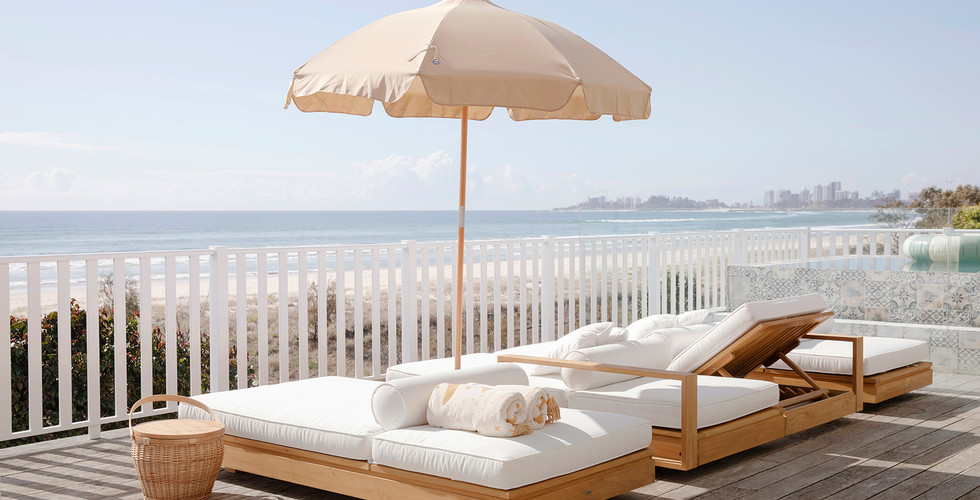 Another angle of the perfect sun loungers sitting under a sunbrella looking out over the beach