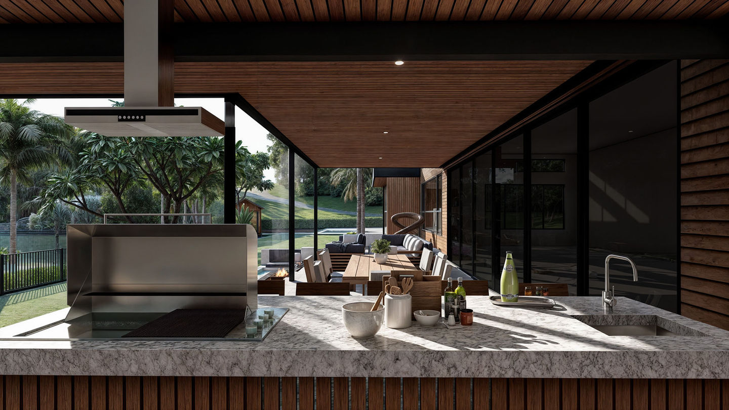 From behind the counter of the purpose built BBQ and outdoor kitchen overlooking the outdoor living space.