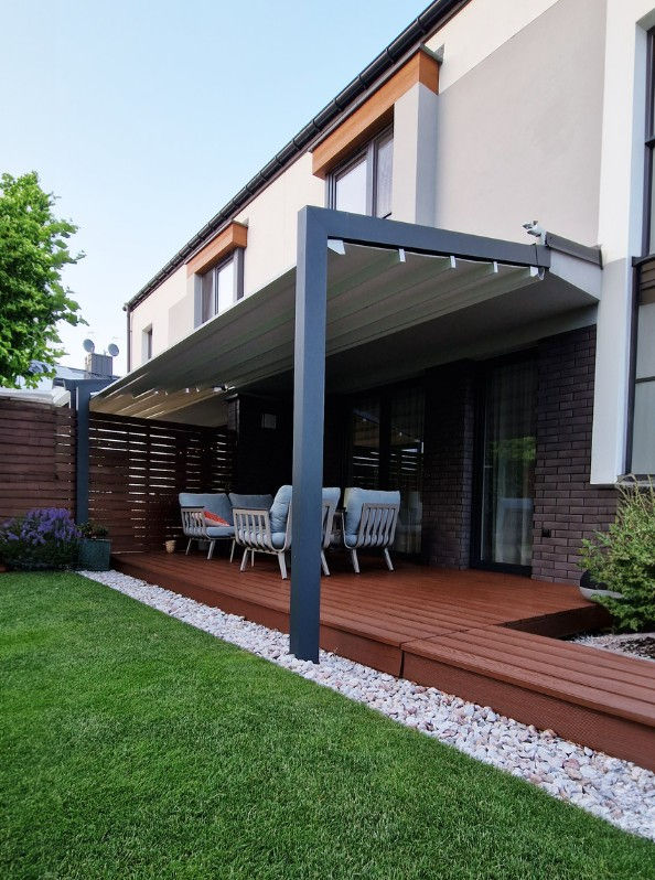 Dark framed canvas veranda shading a patio beside a house