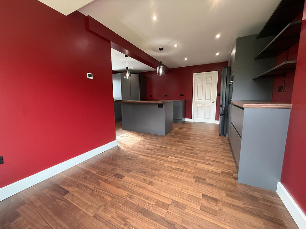 Open kitchen with grey units, walnut worktops and wood-effect floor