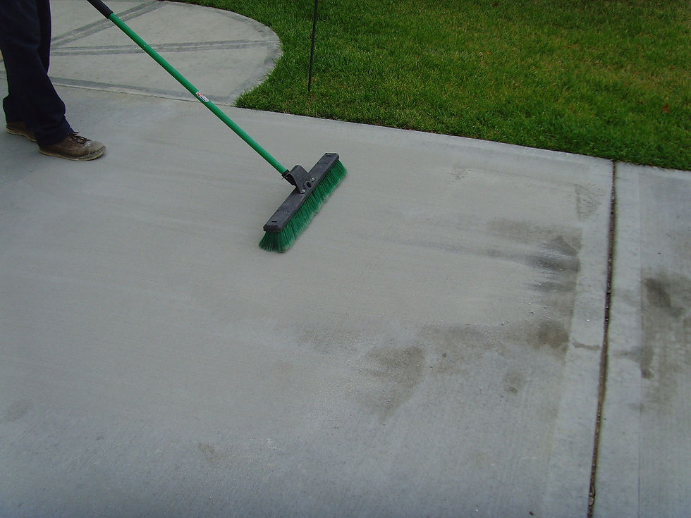 brushing off oil stain with oil stain remover