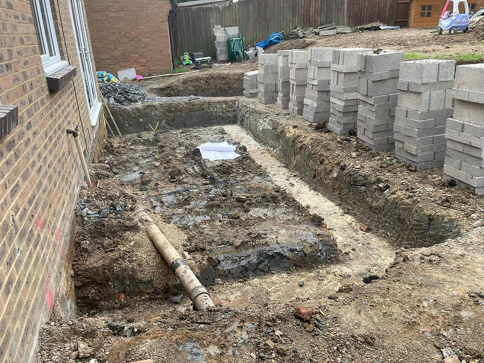 Excavated footings for an extension with blocks stacked alongside