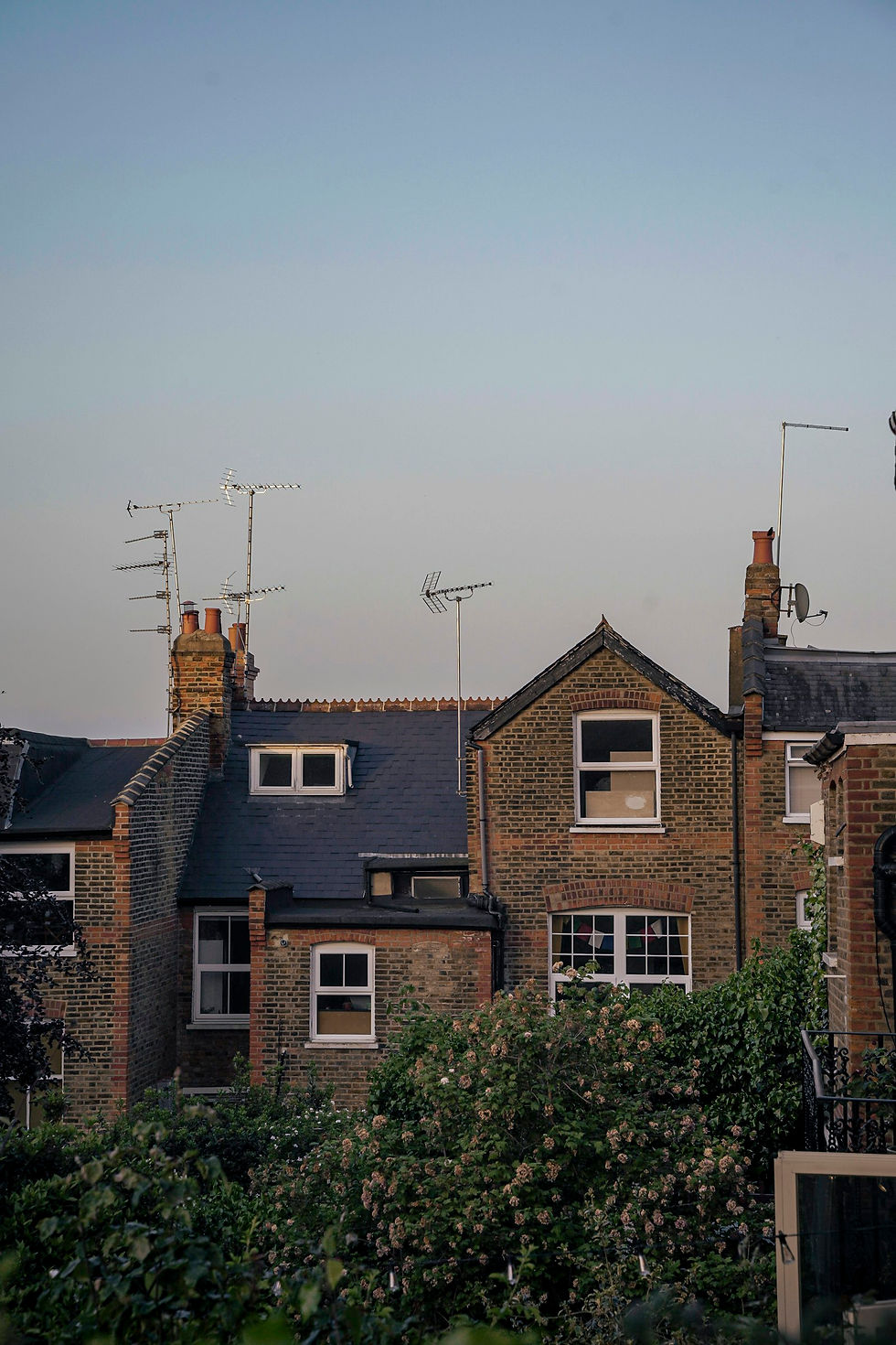 Rear of a brick terraced house with a box dormer on the roof