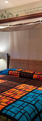 Bright, vibrant colors in a stained glass layout of the Chautauqua Room quilt