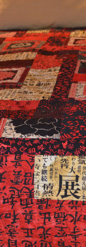 Bright, bold reds with printed symbols and letters in the Japanese Room quilt