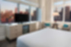 A room at Ink 48 eco hotel in New York City, with a window looking out to skyscrapers