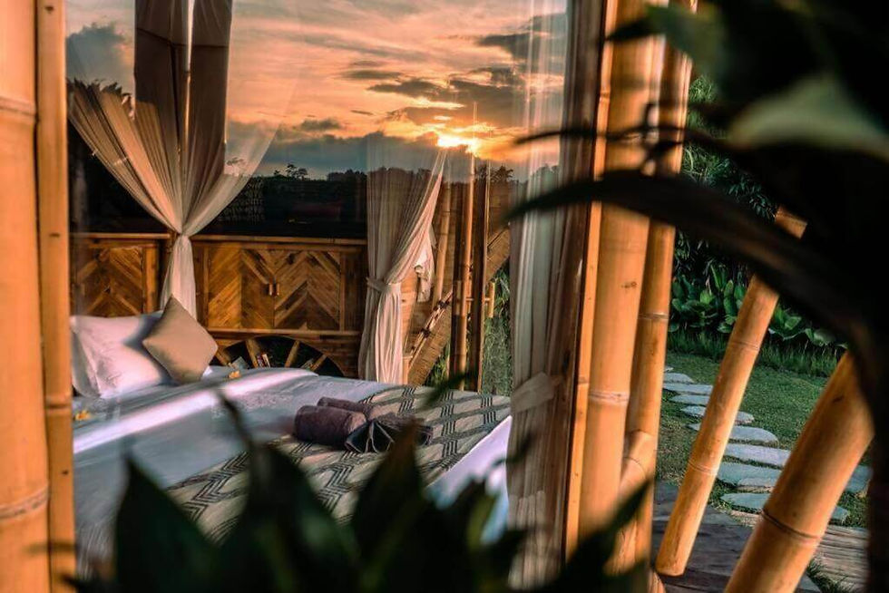 a reflection of a sunset in the glass of one of the eco villas at Camaya Bali eco resort