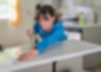 Woman spraying and wiping down counter