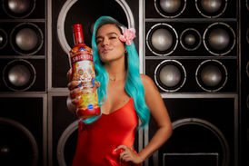 Karol G with Smirnoff and Background of speakers