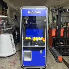 Blue Trip.com-branded claw machine rental filled with plush prizes in Singapore