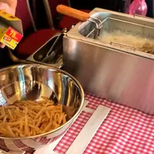 Basket of crispy fries at a live fries station carnival food stall Singapore