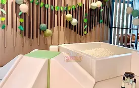 Sage green and white soft play rental at a jungle-themed birthday party