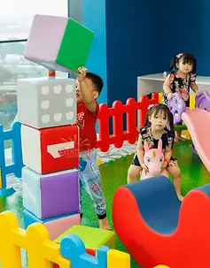 Colourful soft play rental set up at a Singapore cafe with tunnel, ball pit and safety fence