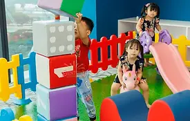 Children playing with giant foam blocks and slide at a soft play rental Singapore