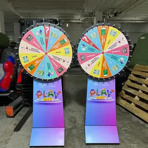 Two custom-branded Prudential spin wheels at corporate D&D event – 16-section prize wheels with company logo, Singapore