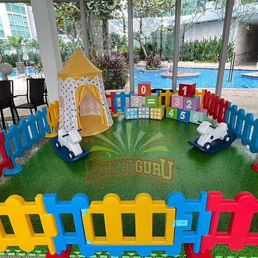 Children playing in a vibrant soft play area with padded obstacles and interactive play structures