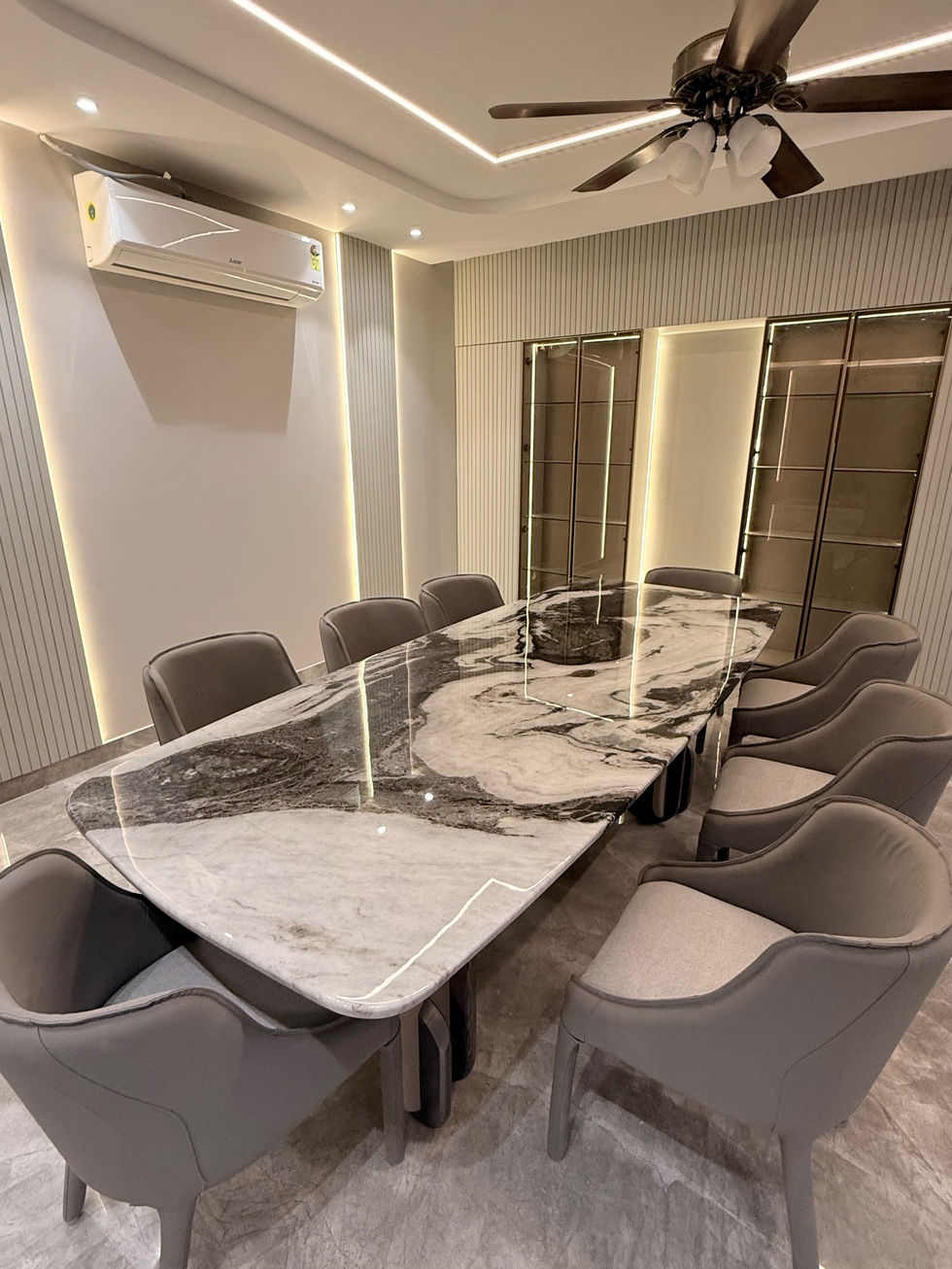 Elegant conference room with marble table and chairs.