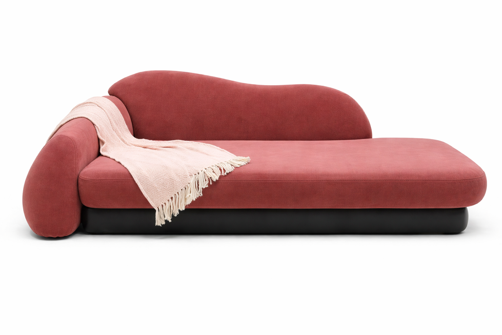Red chaise lounge with a draped beige blanket.