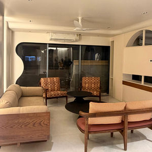 Modern living room with beige sofas and armchairs.