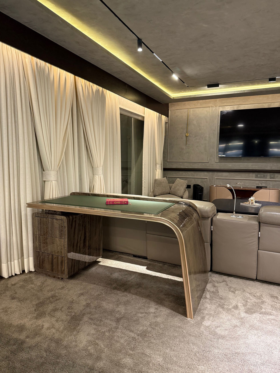 Luxurious room with elegant furniture and large TV.