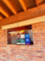 TV mounted to brick exterior wall