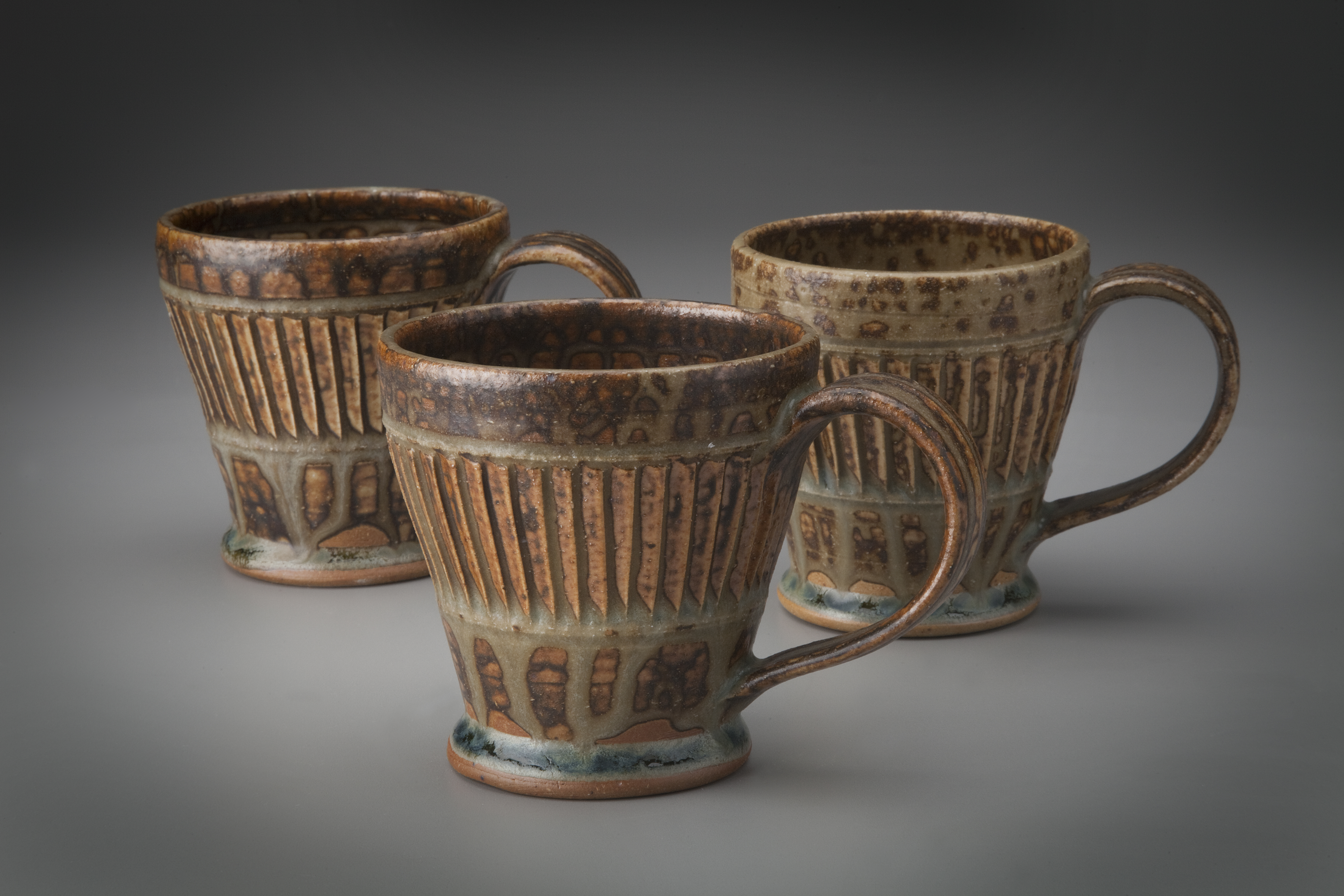 Vertically carved mugs