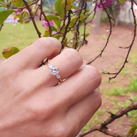 Hand with Tayha Designs rose gold engagement ring