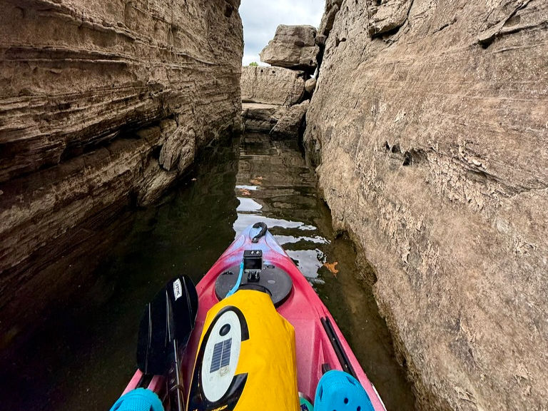 Red kayak between limestone walls on Beaver Lake