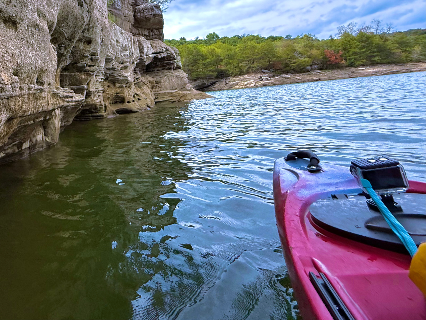 Red kayak beside limestone cliffs on Beaver Lake