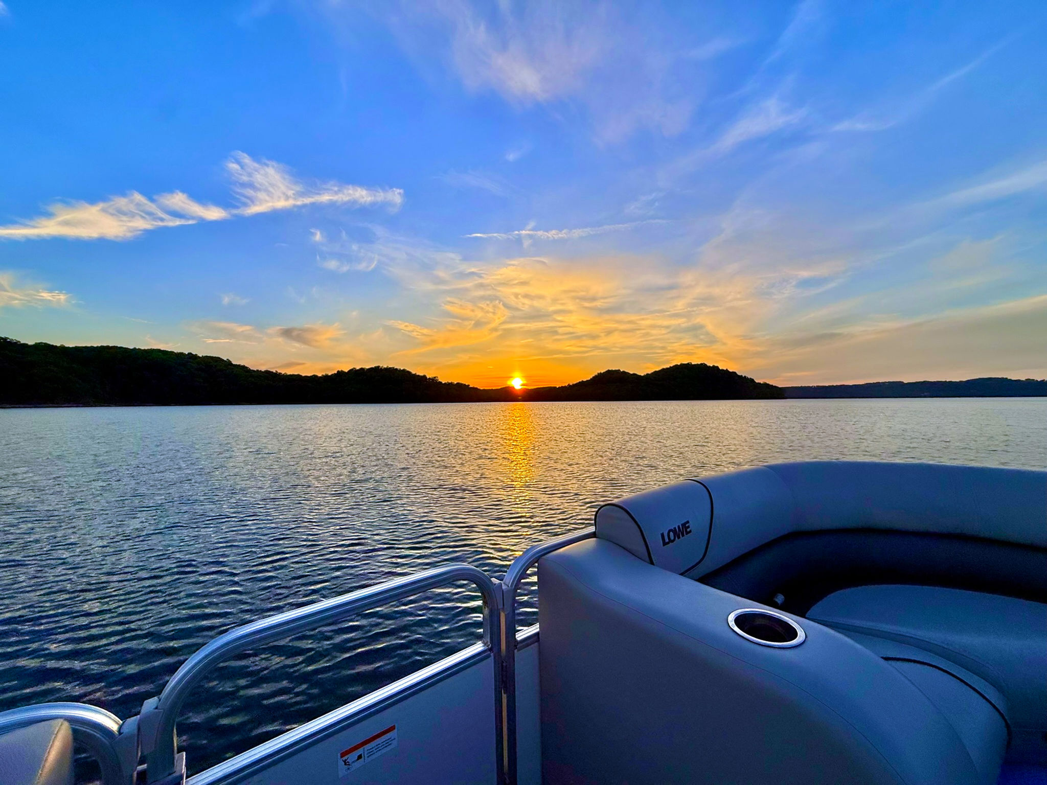Sunset over Beaver Lake viewed from a pontoon boat