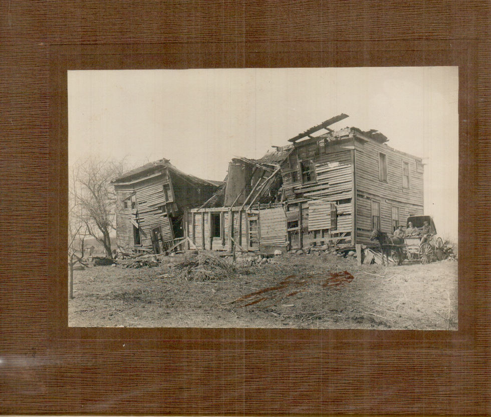 A falling-down building with 3 men in horse & buggy
