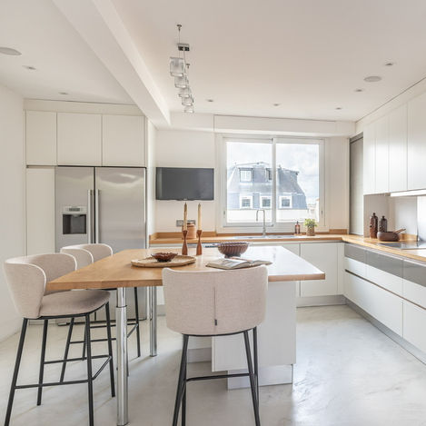 cuisine bloc centrale bar 
tabourets bouclette baignée de lumière adresse de prestige standing haut de gamme élégance home staging raffinement turnkey authenticité 