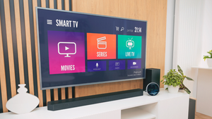 Smart TV on a wooden panel wall showing a colorful home screen with options, symbolizing access models in modern finance.