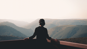 Person in black stands with arms on railing, symbolizing the moral status of reversibility