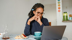 Woman with a laptop looks focused, symbolizing non-ownership economic welfare and the hidden cost of waiting