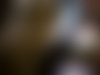 A tattoo artist tattooing a client's upper arm