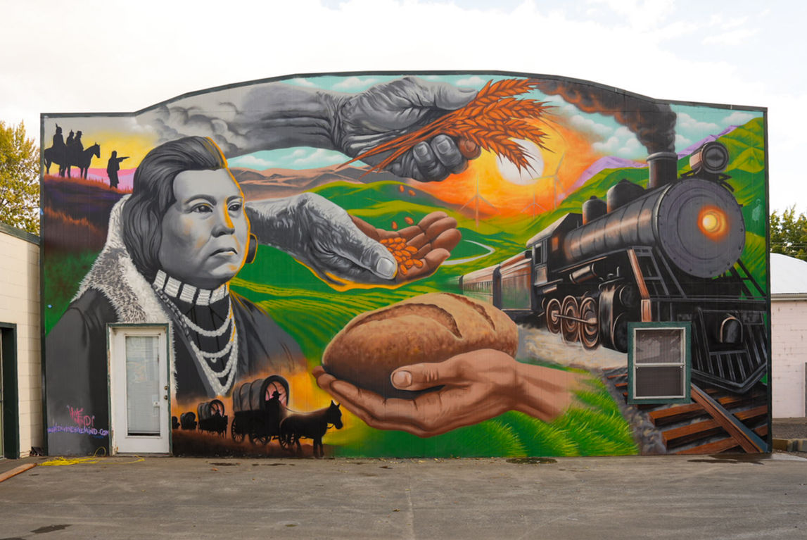 Mural in Dayton, Washington, for Columbia County sesquicentennial of Native American chief, bread and grain, pioneers, and train.